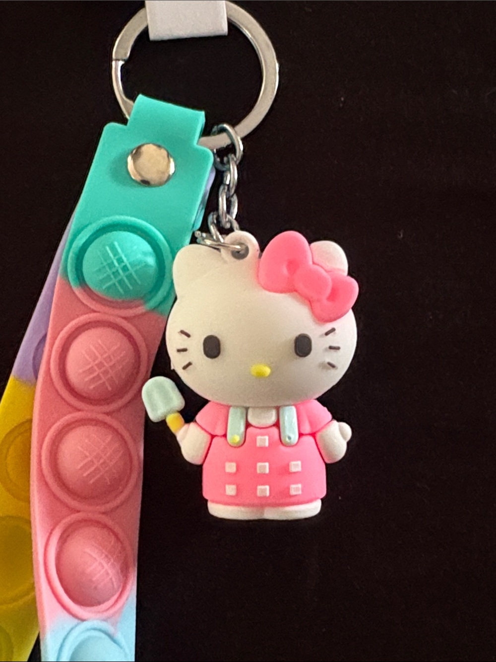 Fashion Jewelry Hello Kitty Keychain with Pink Charm and Multicolor Pop-It Strap - Picture 2 of 2